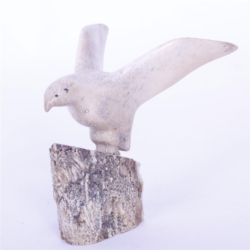 Appraisal: Inuit carved whale bone bird on fossilized whale bone base