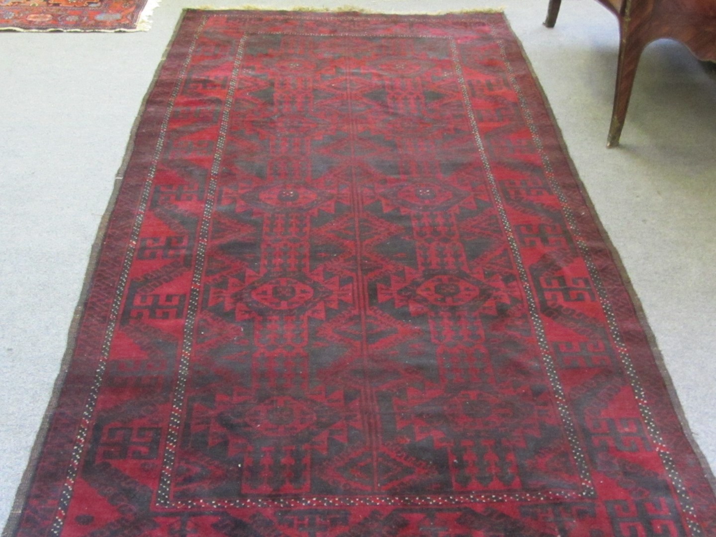 Appraisal: A Baluchistan rug the madder field with a black design