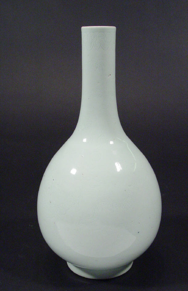 Appraisal: Chinese porcelain white glazed bottle vase incised with a dragon