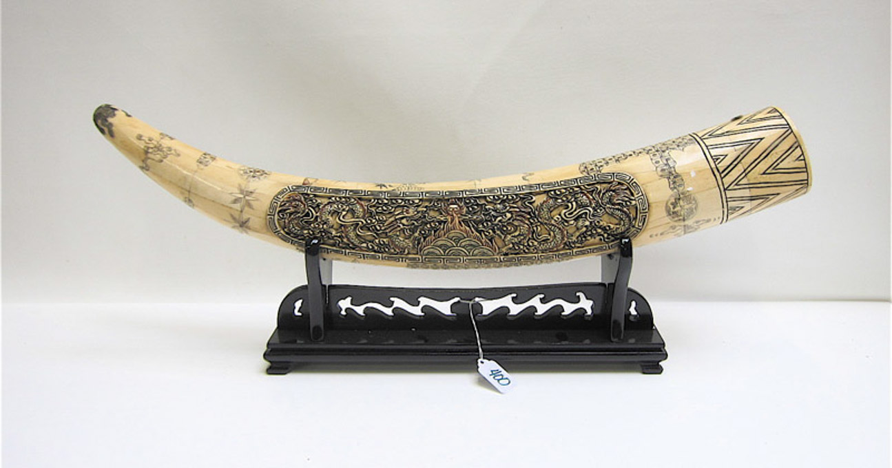 Appraisal: CHINESE PIECED BONE TUSK ON STAND the sculptured tusk having