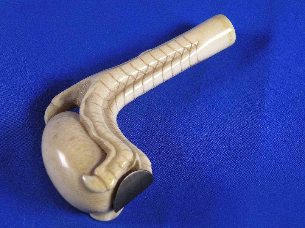 Appraisal: A late thC Japanese ivory walking stick handle carved in