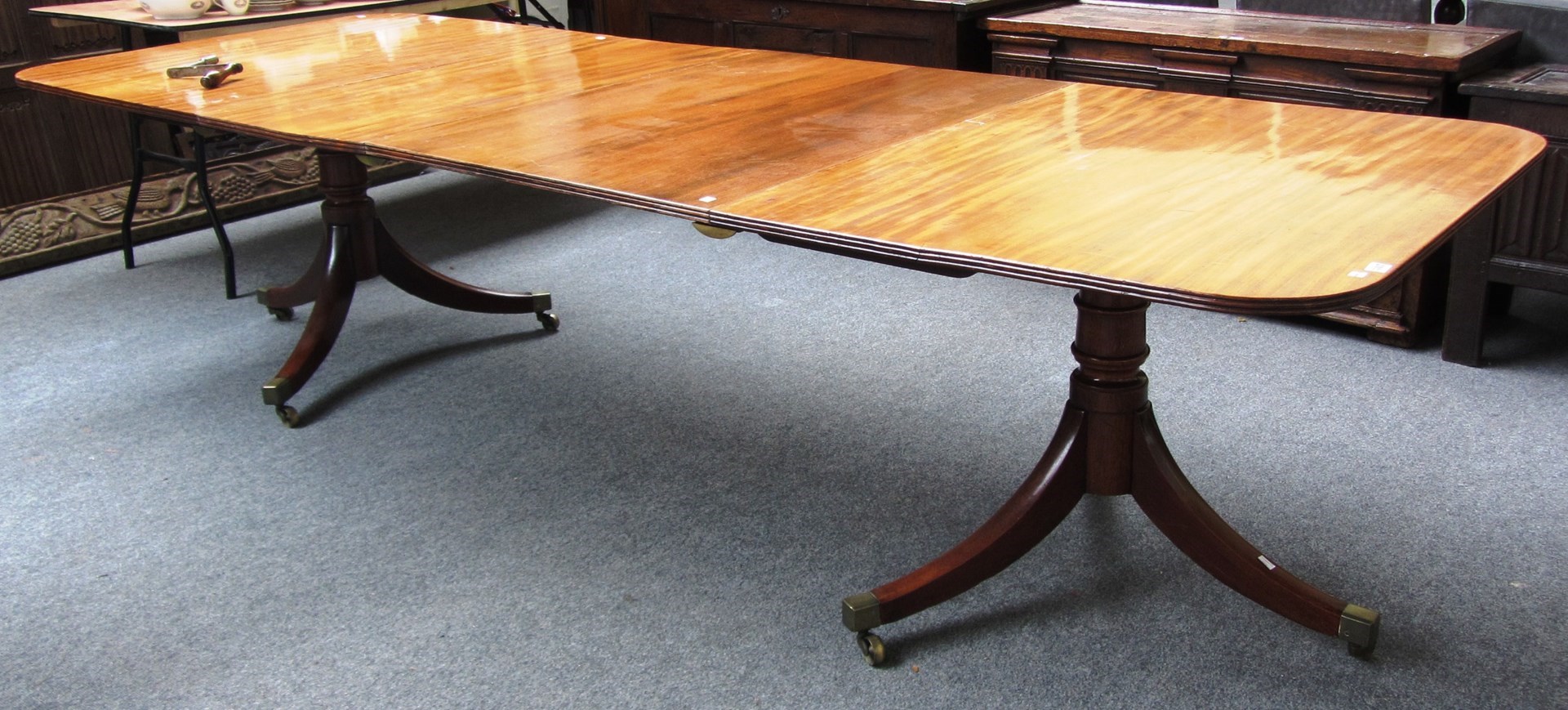 Appraisal: A George III and later twin pedestal dining table the