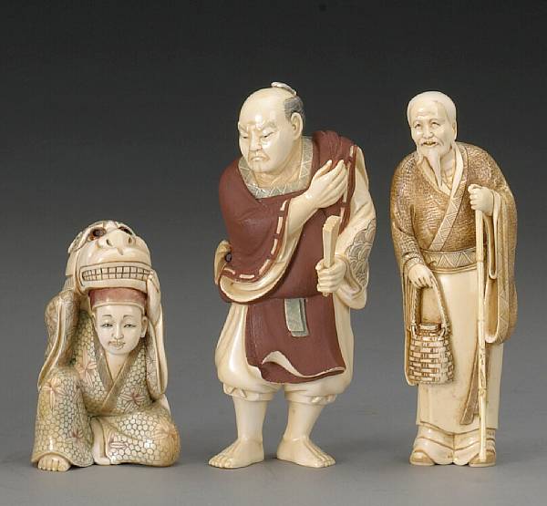 Appraisal: Three stained ivory figural carvings The first of an indignant