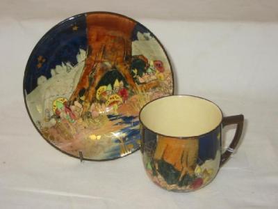 Appraisal: A ROYAL DOULTON CUP AND SAUCER printed and painted with