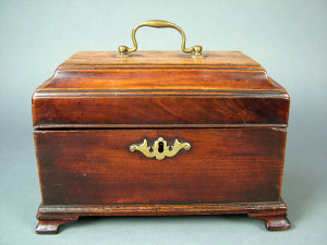 Appraisal: A George III mahogany tea caddy with raised lid shaped