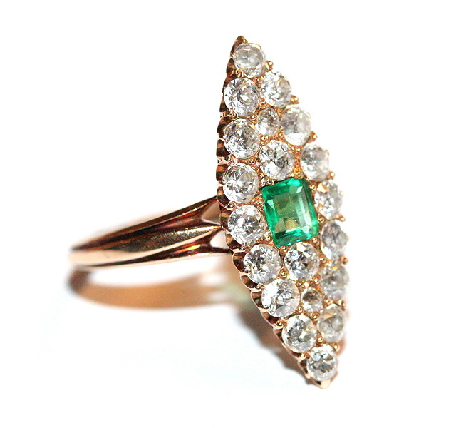 Appraisal: AN EMERALD AND DIAMOND SET MARQUISE SHAPED RING central square