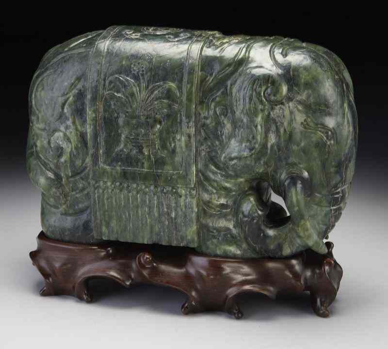 Appraisal: Chinese Qing carved spinach jade elephantwith a saddle on its'