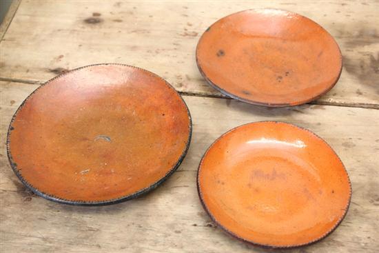 Appraisal: THREE REDWARE PLATES All with coggled rims ''d ''d ''d