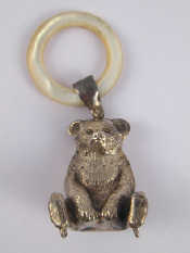 Appraisal: A silver teddy bear teether with m o p ring