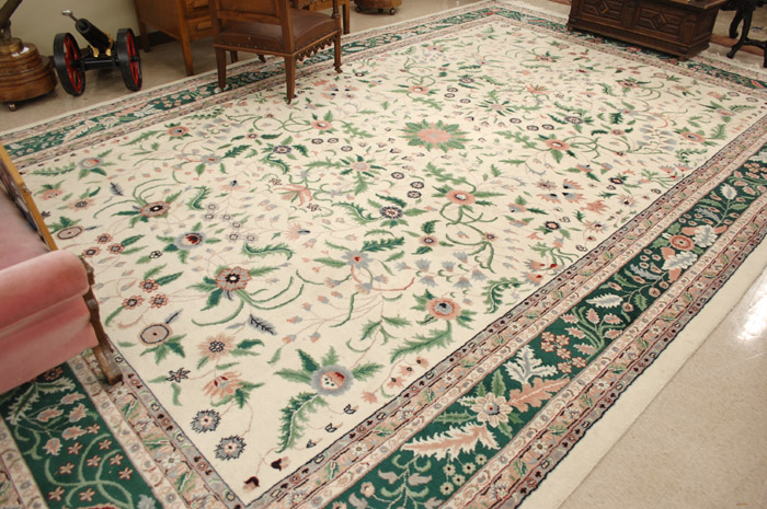 Appraisal: HAND KNOTTED ORIENTAL CARPET Indo-Persian overall flower and green leaf