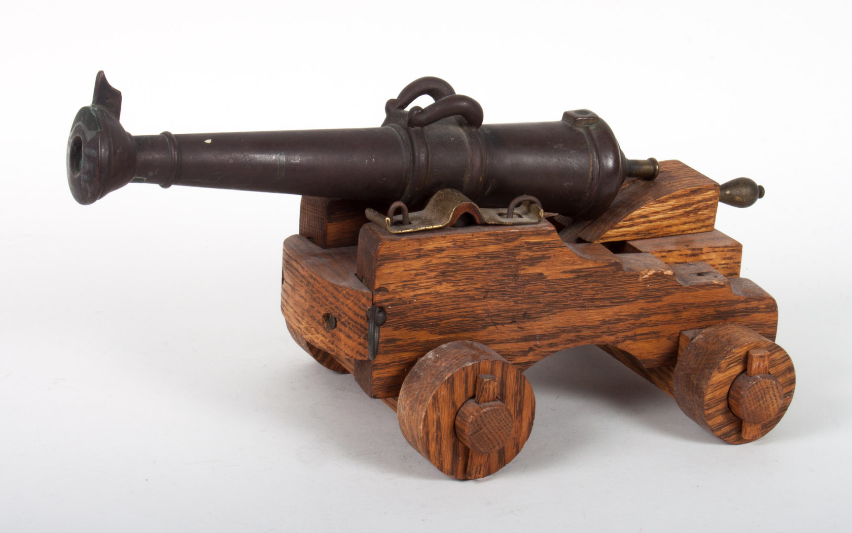 Appraisal: Miniature bronze and wood table cannon late th early th