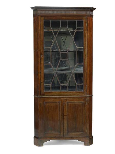 Appraisal: A George III mahogany standing corner cabinet the projecting dentil