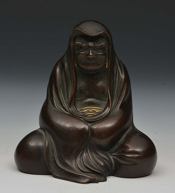 Appraisal: A JAPANESE BRONZE OKIMONO of a seated Daruma his flowing