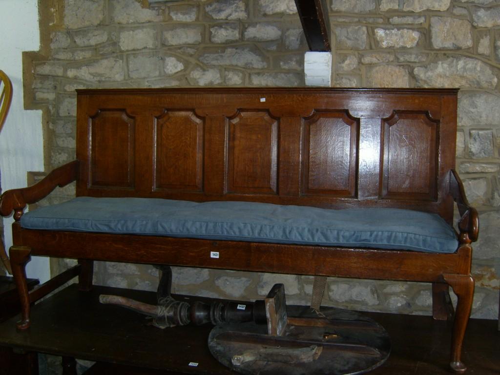 Appraisal: A Georgian oak settle the back enclosing five shaped and