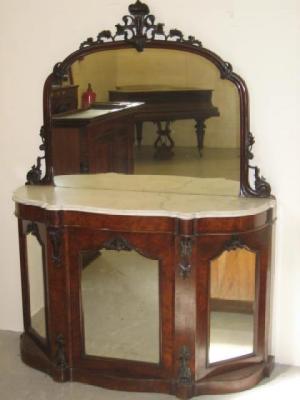 Appraisal: A VICTORIAN WALNUT CHIFFONIER of serpentine form the arched mirrored