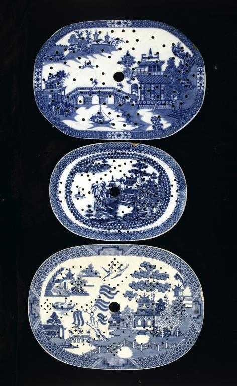 Appraisal: THREE BLUE PRINTED EARTHENWARE DRAINER Long Bridge and other patterns