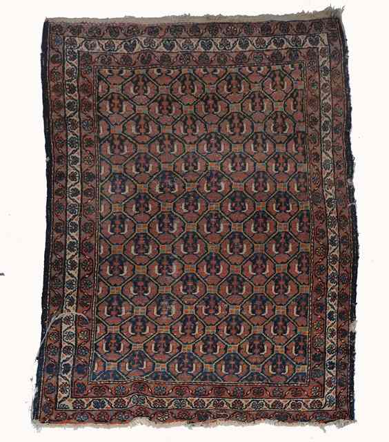 Appraisal: AN OLD PERSIAN RUST GROUND RUG decorated a central geometric