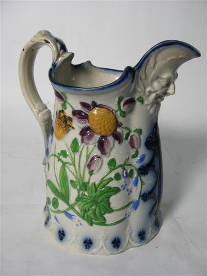 Appraisal: A colorful pottery pitcherHaving a mask decorated spout and overall