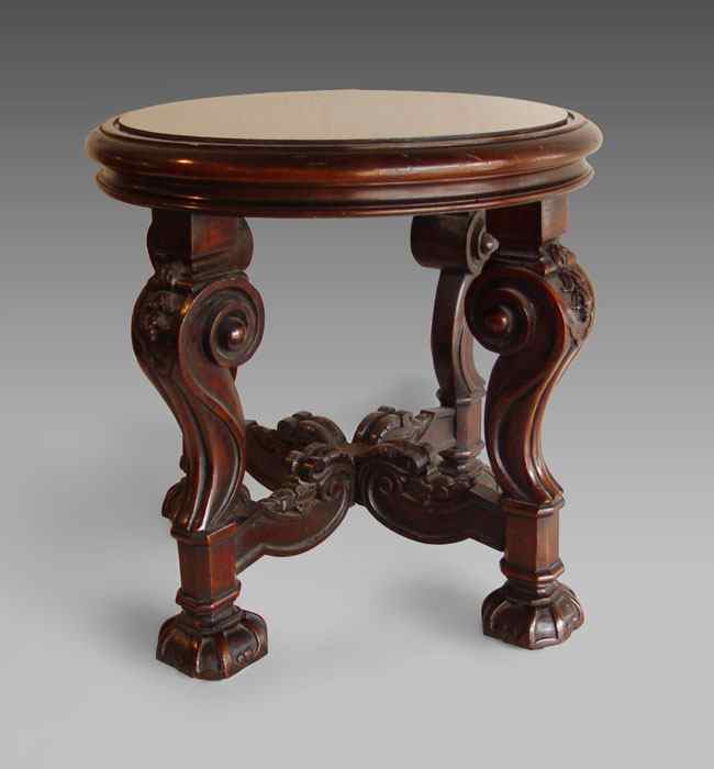 Appraisal: CARVED MAHOGANY SIDE TABLE Round top on ornate carved scroll