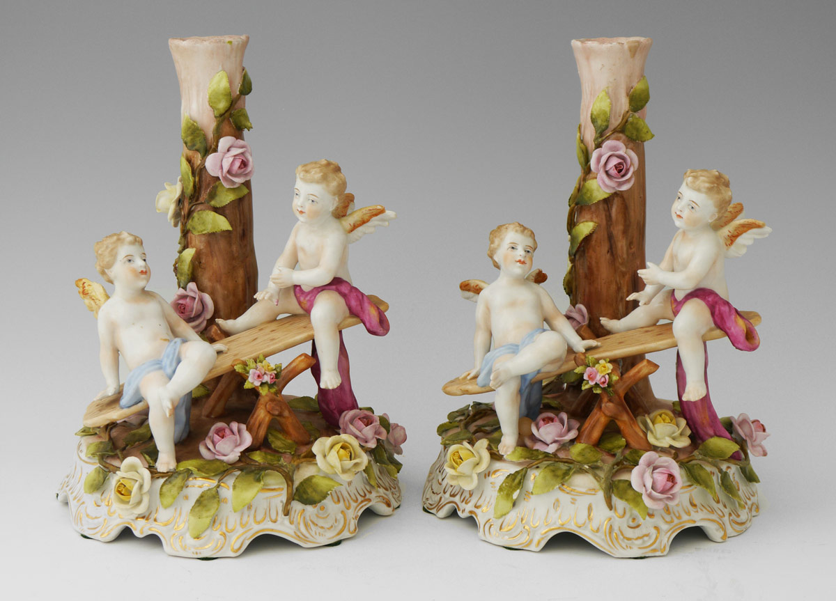 Appraisal: PAIR OF SCHIERHOLZ PORCELAIN FIGURAL CANDLEHOLDERS Depicting children at play