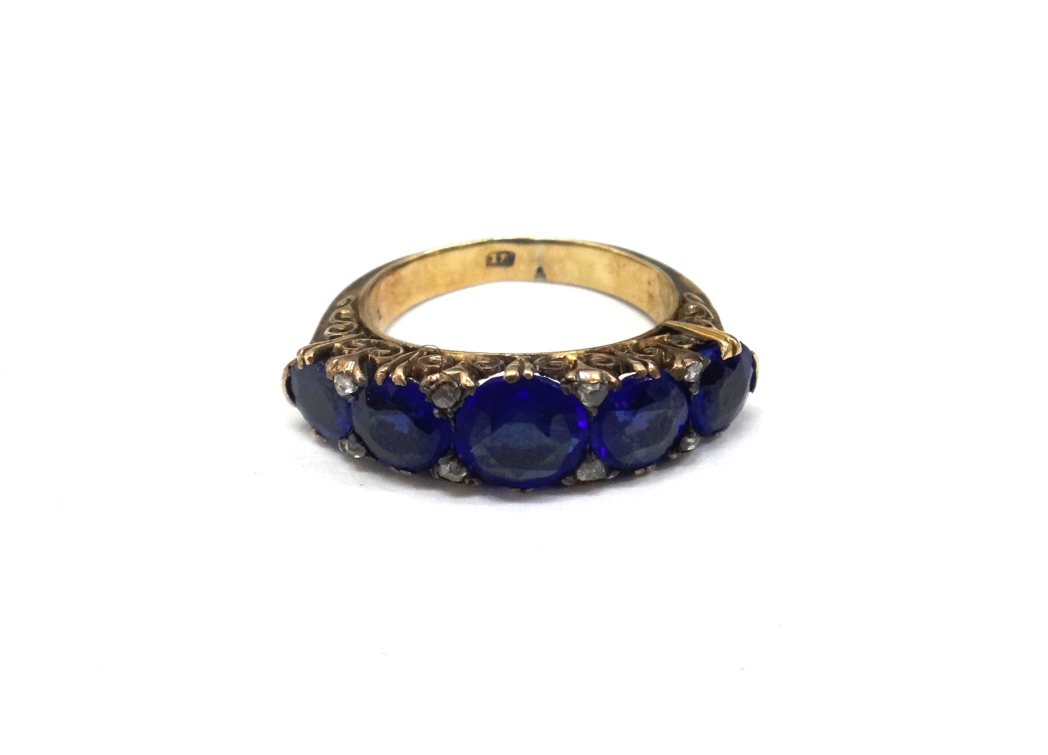 Appraisal: A gold and blue garnet-topped doublet five-stone ring in a