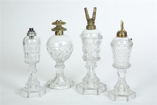 Appraisal: FOUR GLASS OIL LAMPS Pattern glass three are probably Sandwich