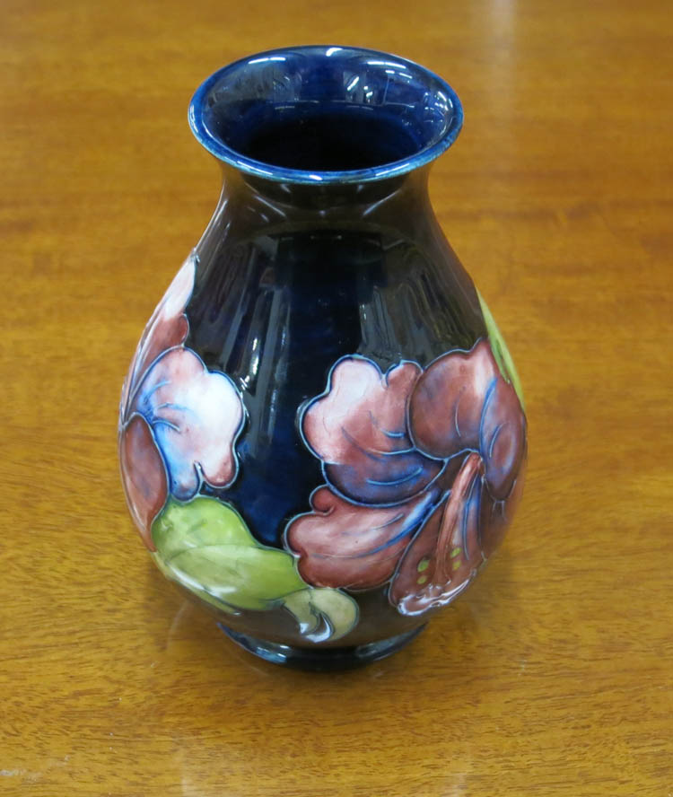 Appraisal: MOORCROFT ART POTTERY VASE Hibiscus pattern pear shaped cobalt blue