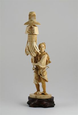 Appraisal: A Japanese ivory carving of a man holding an impressive