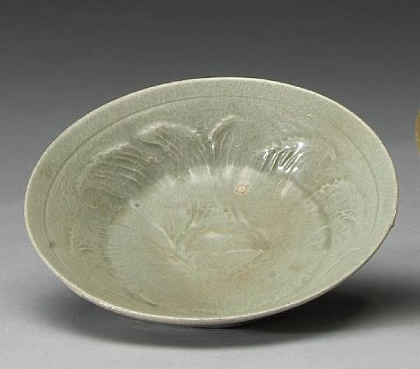 Appraisal: A celadon glazed stoneware shallow bowl with impressed peony design