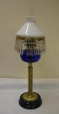 Appraisal: A VICTORIAN BRASS OIL LAMP the blue glass reservoir having