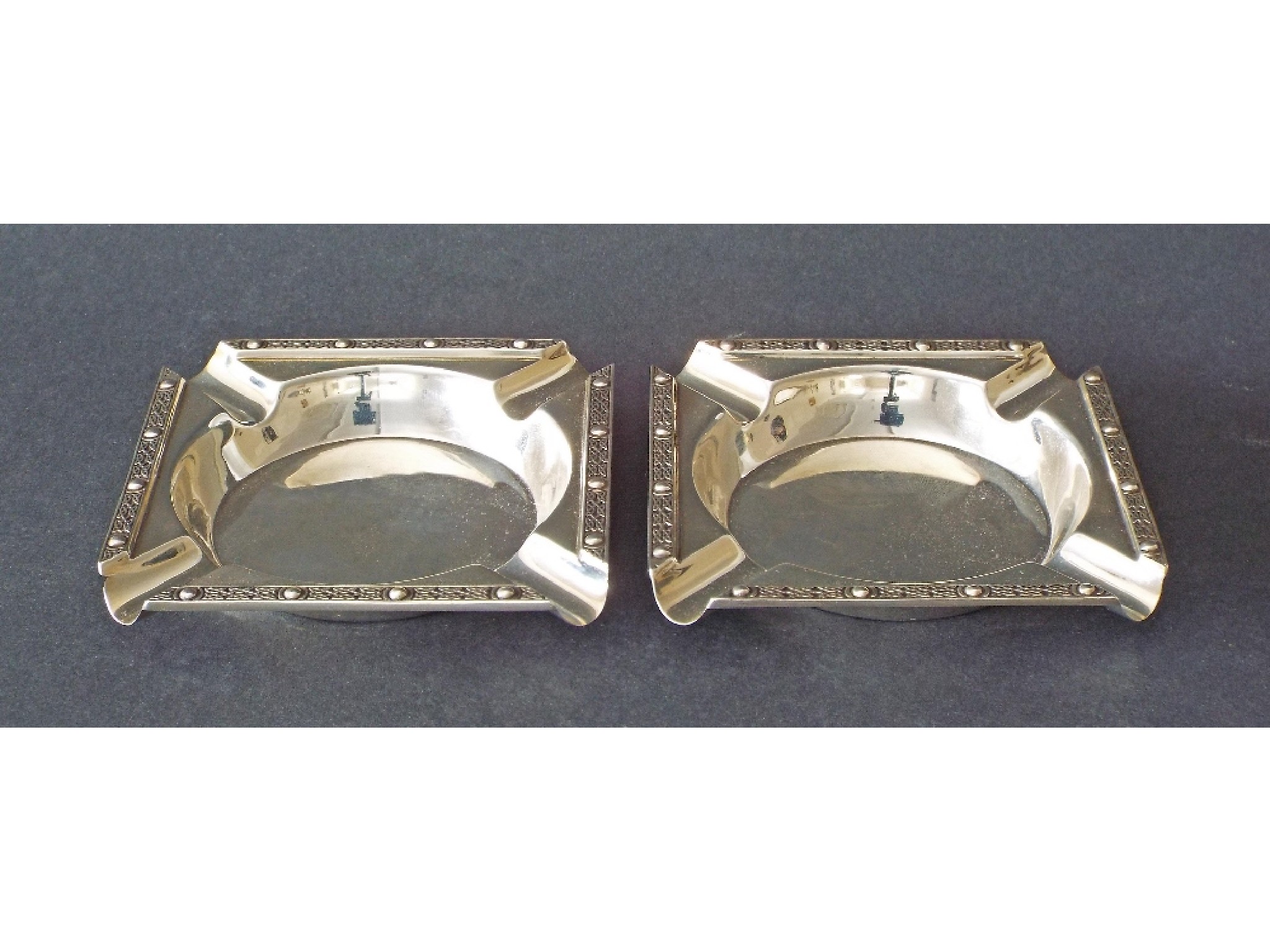 Appraisal: Pair of silver square ashtrays with Celtic type bands maker