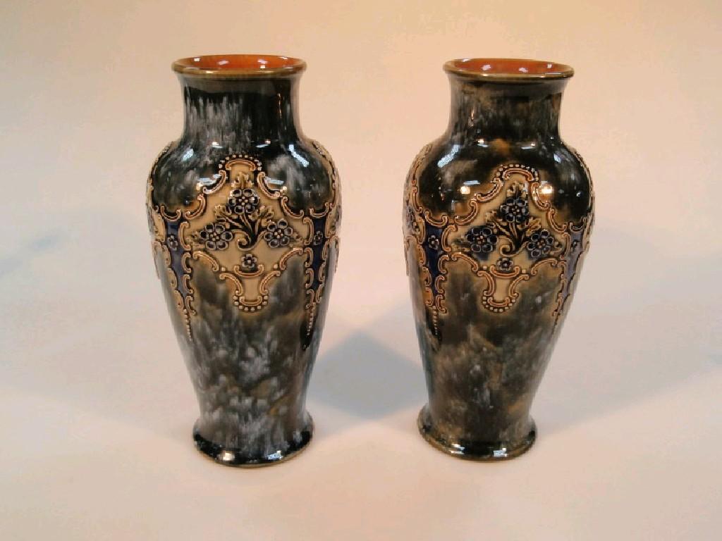 Appraisal: A pair of Royal Doulton stoneware baluster vases relief decorated