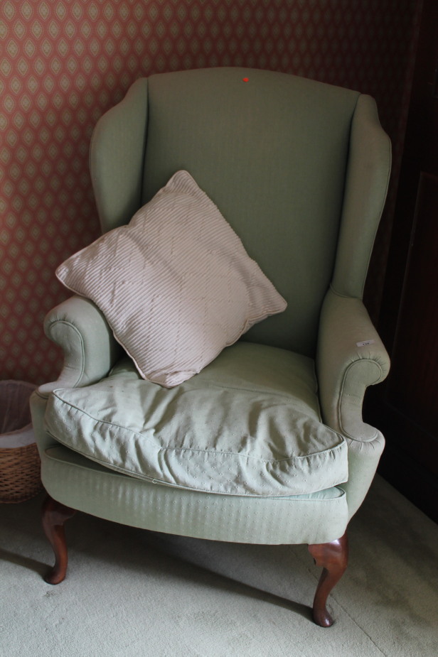 Appraisal: A Queen Anne style wing back armchair with cabriole legs