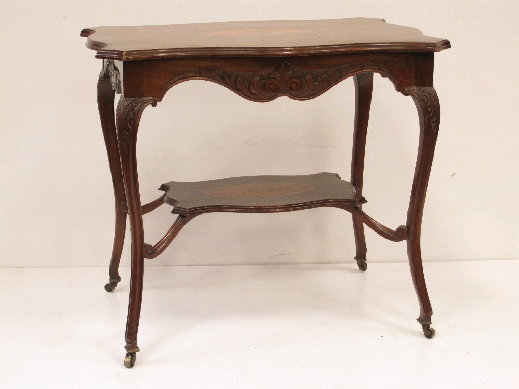 Appraisal: An Edwardian mahogany serpentine shaped two tier Occasional Table with