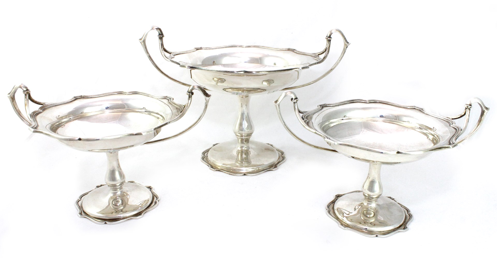 Appraisal: A garniture of three silver twin handled tazzae comprising one