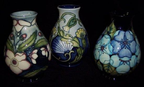 Appraisal: Three Moorcroft small pear shaped vases painted flowers on a