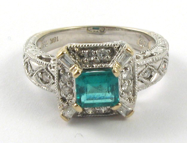 Appraisal: DIAMOND EMERALD AND EIGHTEEN KARAT WHITE GOLD RING centering a