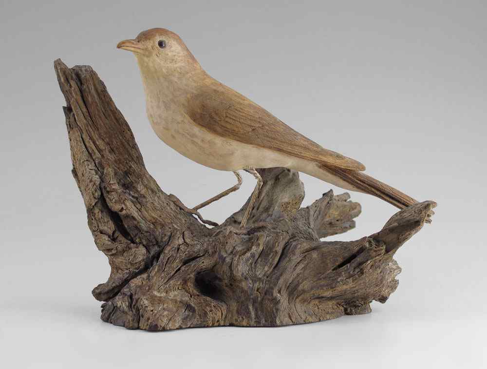 Appraisal: DAN JOHNSON CARVED BIRD Most likely a thrush exquisitely carved