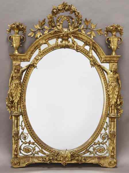 Appraisal: Louis XVI style carved gilt mirror surmounted bya floral wreath