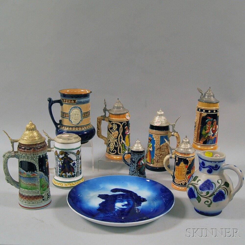 Appraisal: Group of Pitchers Steins and a Plate seven figural relief