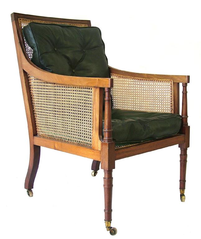 Appraisal: Regency mahogany bergere library armchair with square cane back arms