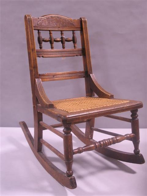 Appraisal: VICTORIAN CANED CHILD'S ROCKING CHAIR Woods include hickory maple and