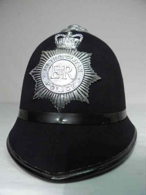 Appraisal: British Metropolitan police helmet Black fabric with metal mounts on