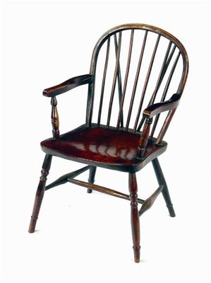 Appraisal: A th century hoop back Windsor armchair in ash elm