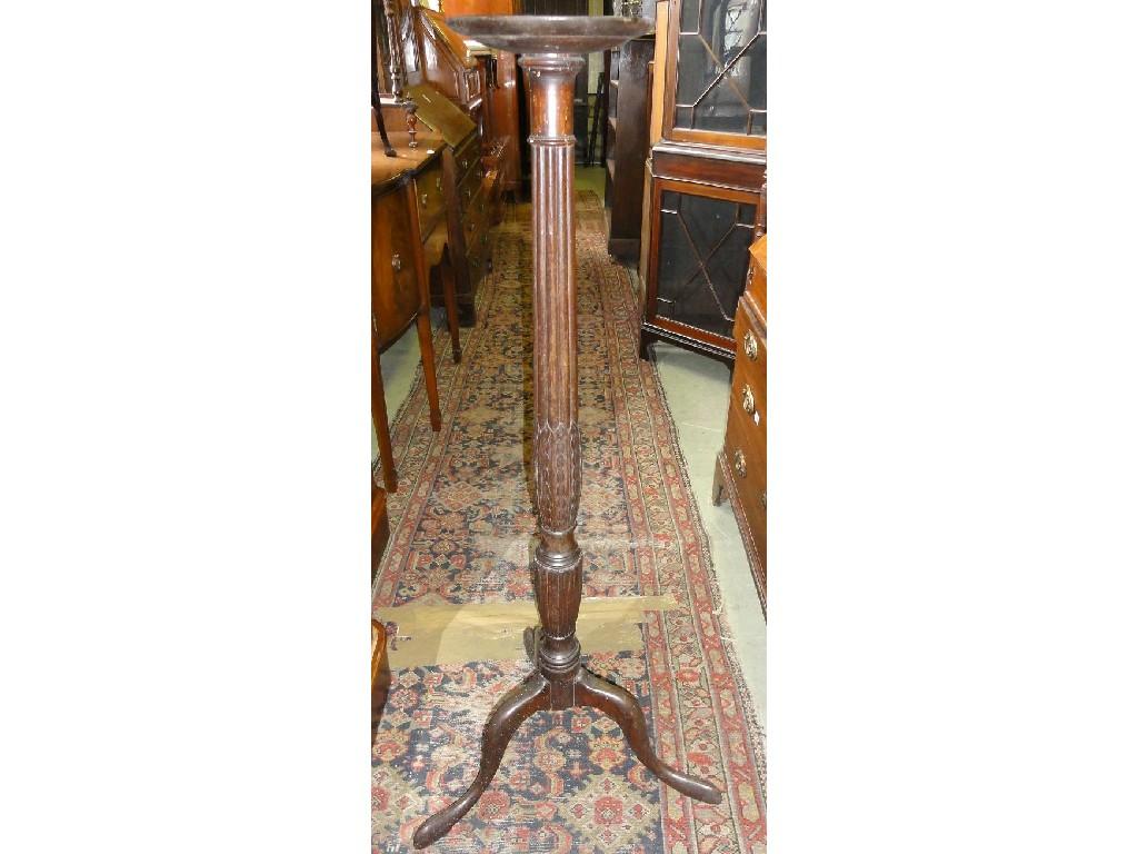 Appraisal: A Georgian style mahogany torchere with reeded vase shaped pillar