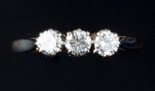 Appraisal: A diamond three stone ring claw set with brilliant-cut diamonds