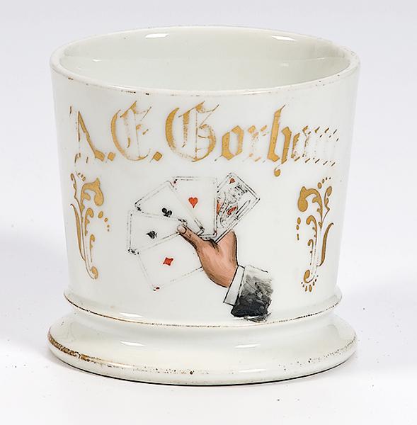 Appraisal: PLAYING CARDS SHAVING MUG Porcelain shaving mug with gilding and