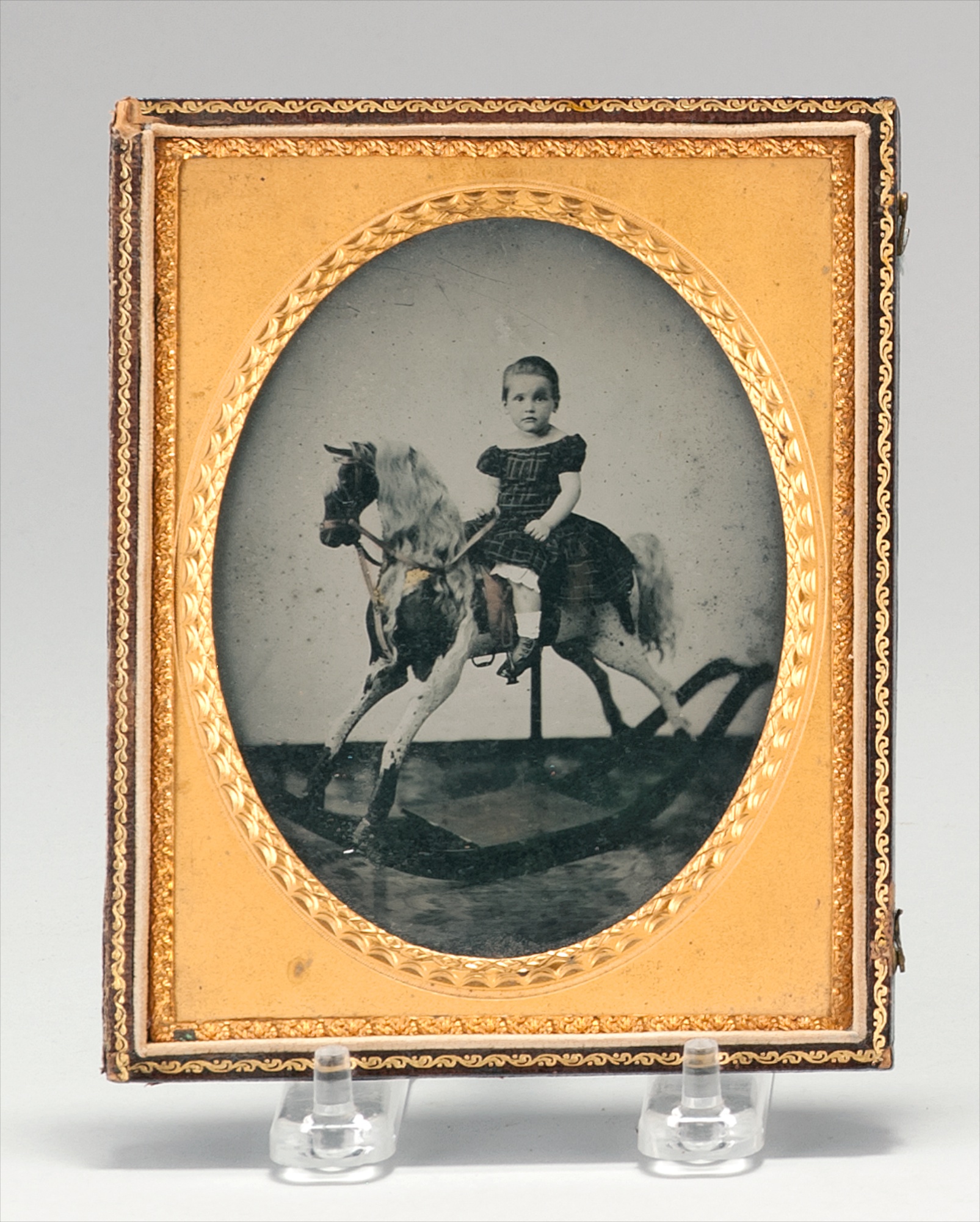 Appraisal: CASED PHOTOGRAPH Mid- th CenturyDepicts a child on a rocking