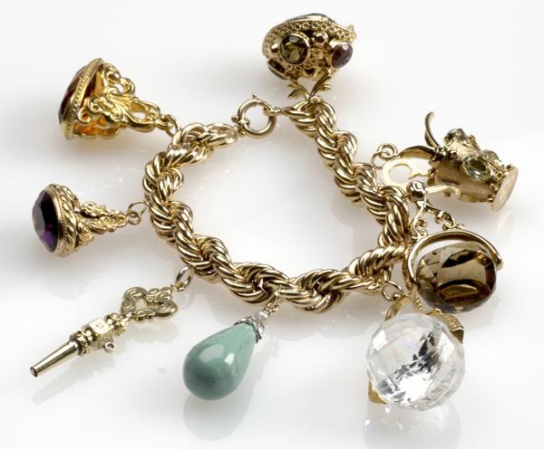 Appraisal: GOLD AND GEMSTONE CHARM BRACELET k rope link suspends eight