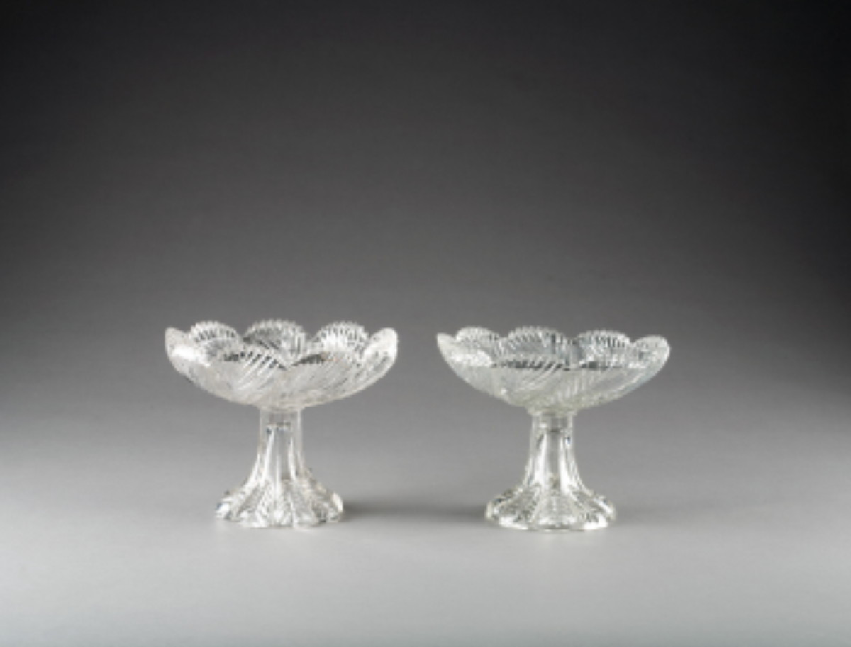 Appraisal: PAIR OF AMERICAN PRESSED COLORLESS GLASS 'LEAF' PATTERN FOOTED NAPPIES